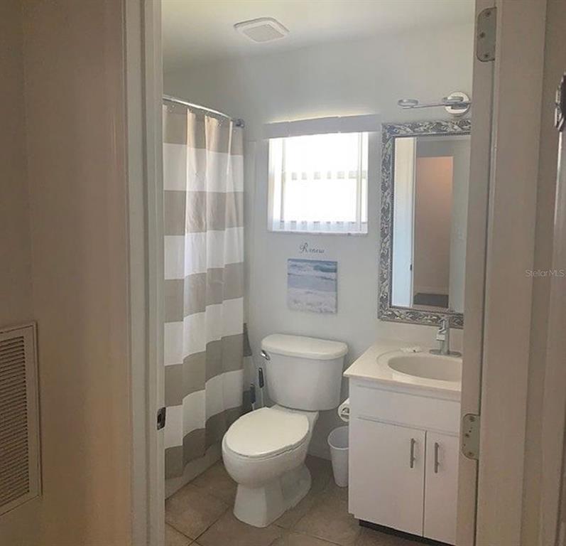 2208 Mystic Ring Loop Kissimmee, FL 34759 - Photo 8 of 12 a bathroom with a toilet sink and shower