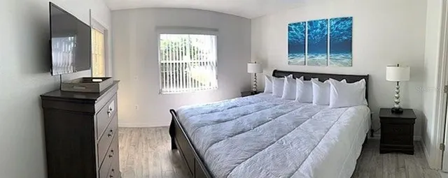 a bedroom with a bed and a dresser