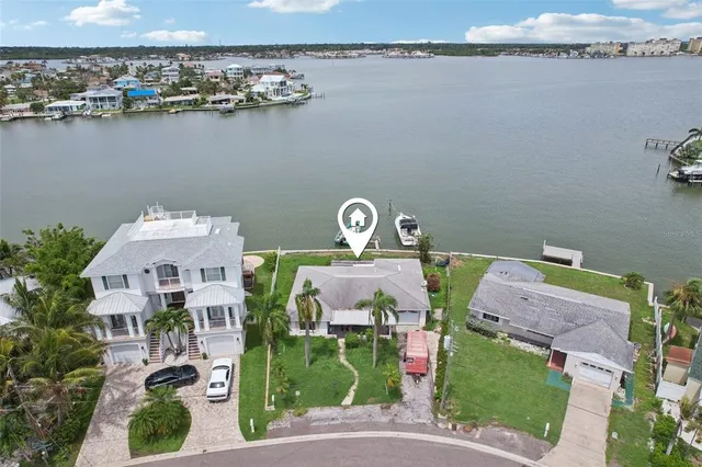 a aerial view of a house with outdoor space and lake view