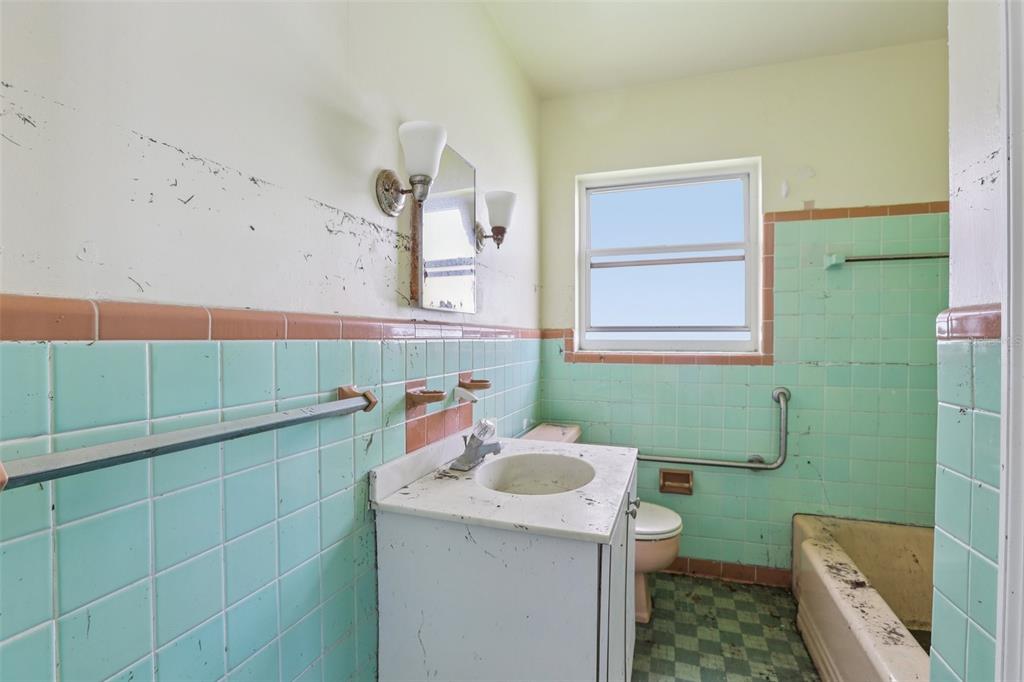 16033 Redington Drive Redington Beach, FL 33708 - Photo 11 of 26 a bathroom with a sink a toilet and mirror