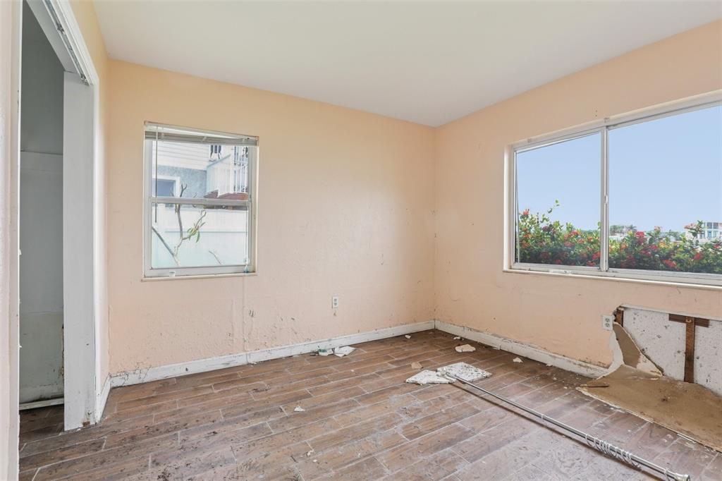 16033 Redington Drive Redington Beach, FL 33708 - Photo 12 of 26 a view of a room that has a bed and chair in it