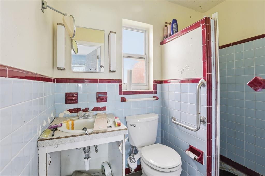 16033 Redington Drive Redington Beach, FL 33708 - Photo 13 of 26 a bathroom with a sink toilet vanity and window