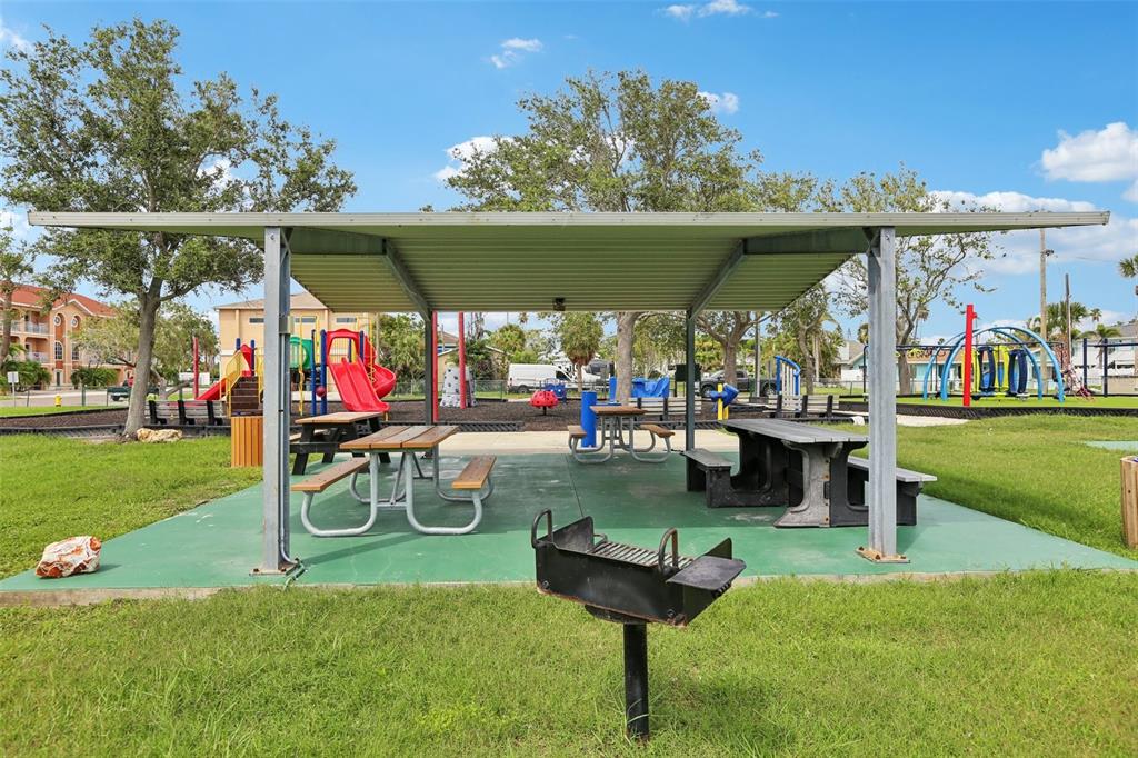 16033 Redington Drive Redington Beach, FL 33708 - Photo 24 of 26 a view of a chairs and table in patio with a yard
