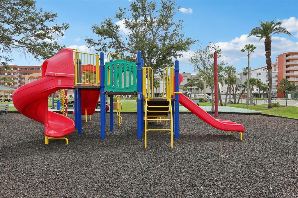 16033 Redington Drive Redington Beach, FL 33708 - Photo 25 of 26 a view of a park with slide and a bench