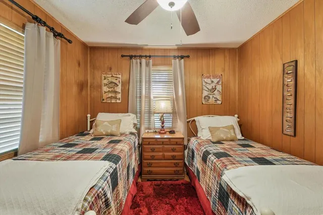 a bathroom with a granite countertop sink mirror vanity and toilet
