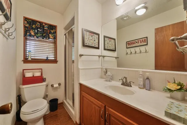 a living room with furniture fireplace and a large window
