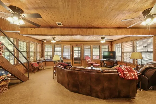 a living room with furniture and large windows