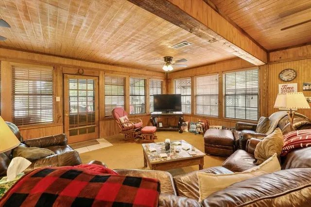 a bedroom with furniture and a flat screen tv