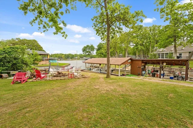 a swimming pool with outdoor seating and yard
