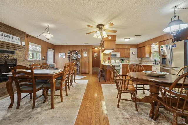 a dining table with chairs and kitchen view