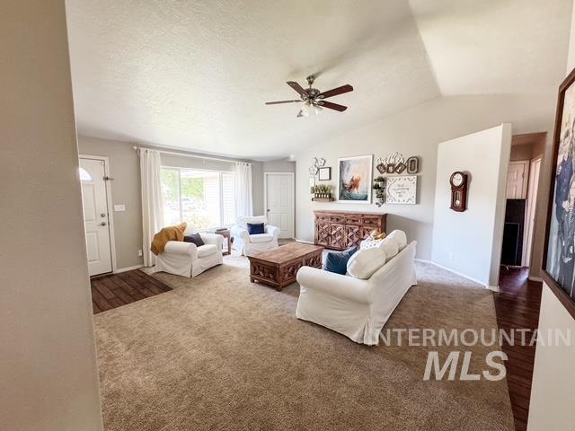 808 O'Leary Way Twin Falls, ID 83301 - Photo 6 of 37 Spacious living area featuring vaulted ceilings, light-toned wall paint, plush carpeting, and a ceiling fan with light fixture