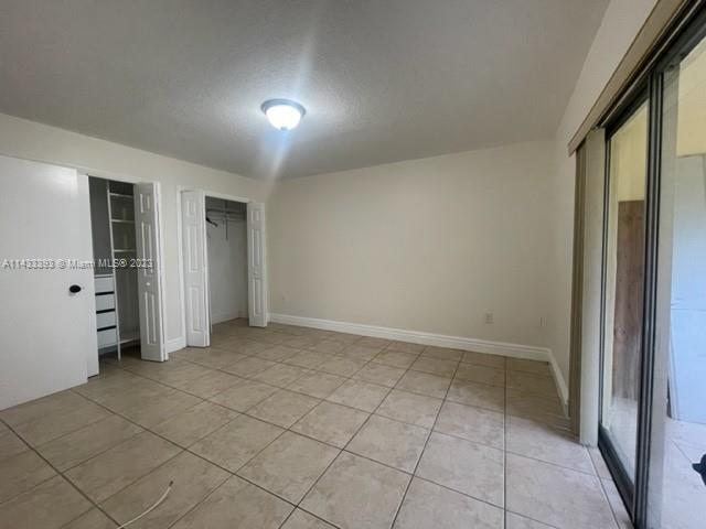 8327 Southwest 137th Avenue, Unit 8327 Miami, FL 33183 - Photo 14 of 31 an empty room with a natural light