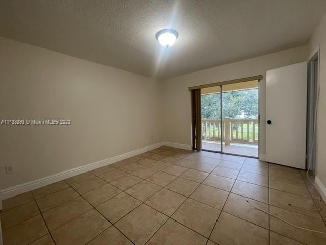8327 Southwest 137th Avenue, Unit 8327 Miami, FL 33183 - Photo 16 of 31 a view of an empty room and a window
