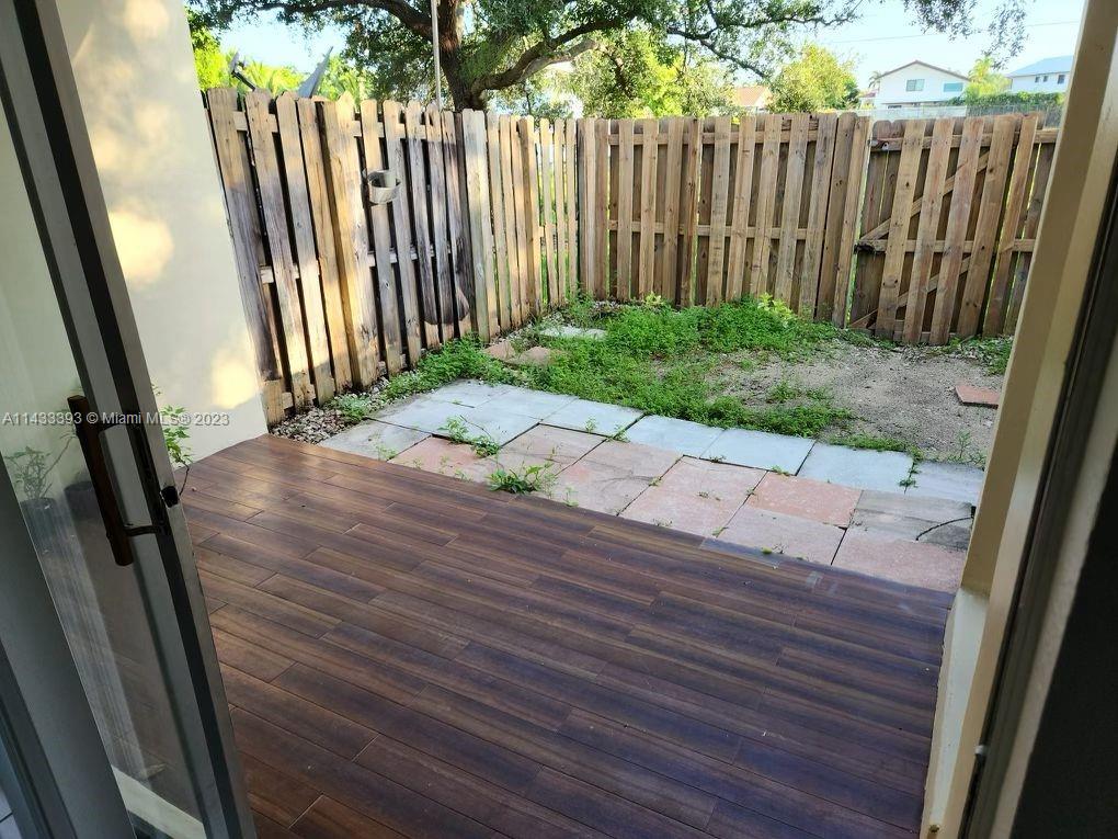 8327 Southwest 137th Avenue, Unit 8327 Miami, FL 33183 - Photo 17 of 31 a view of a backyard with wooden fence
