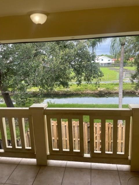 8327 Southwest 137th Avenue, Unit 8327 Miami, FL 33183 - Photo 18 of 31 a view of a balcony with wooden floor & fence