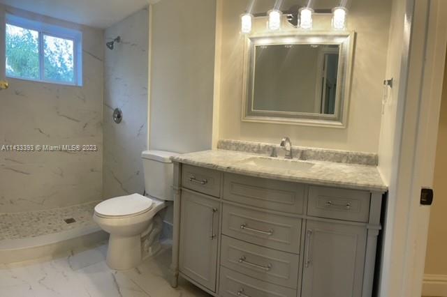 8327 Southwest 137th Avenue, Unit 8327 Miami, FL 33183 - Photo 20 of 31 a bathroom with a sink toilet and a mirror