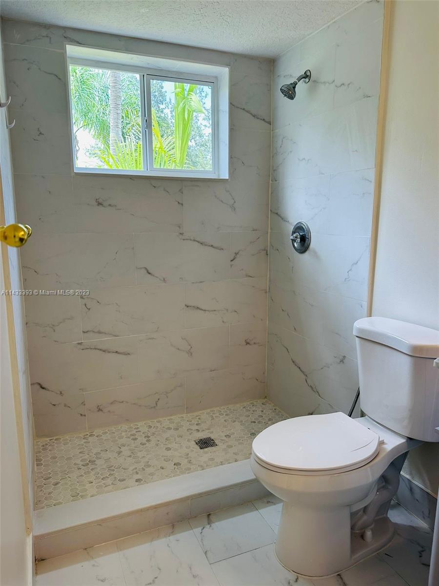 8327 Southwest 137th Avenue, Unit 8327 Miami, FL 33183 - Photo 21 of 31 a bathroom with a toilet and a shower