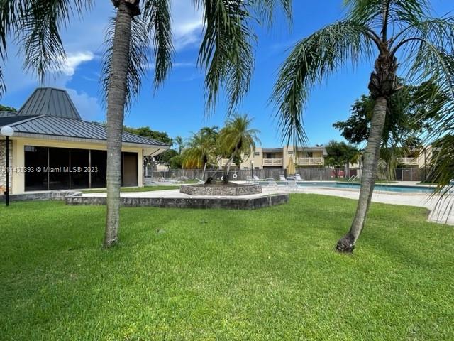 8327 Southwest 137th Avenue, Unit 8327 Miami, FL 33183 - Photo 27 of 31 a view of a swimming pool with a garden