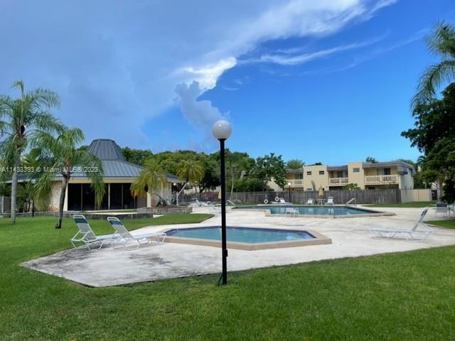 8327 Southwest 137th Avenue, Unit 8327 Miami, FL 33183 - Photo 28 of 31 a view of a playground with a patio