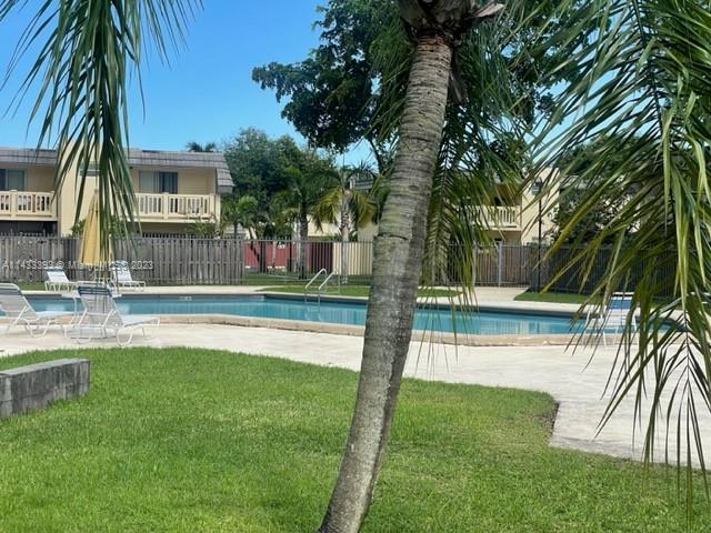 8327 Southwest 137th Avenue, Unit 8327 Miami, FL 33183 - Photo 29 of 31 a view of backyard with swimming pool and green space