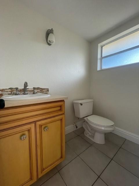 8327 Southwest 137th Avenue, Unit 8327 Miami, FL 33183 - Photo 6 of 31 a bathroom with a toilet sink and mirror