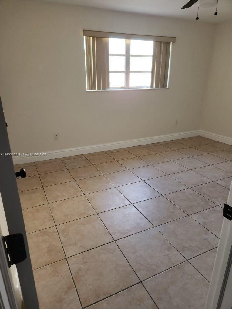 8327 Southwest 137th Avenue, Unit 8327 Miami, FL 33183 - Photo 7 of 31 a view of an empty room and window