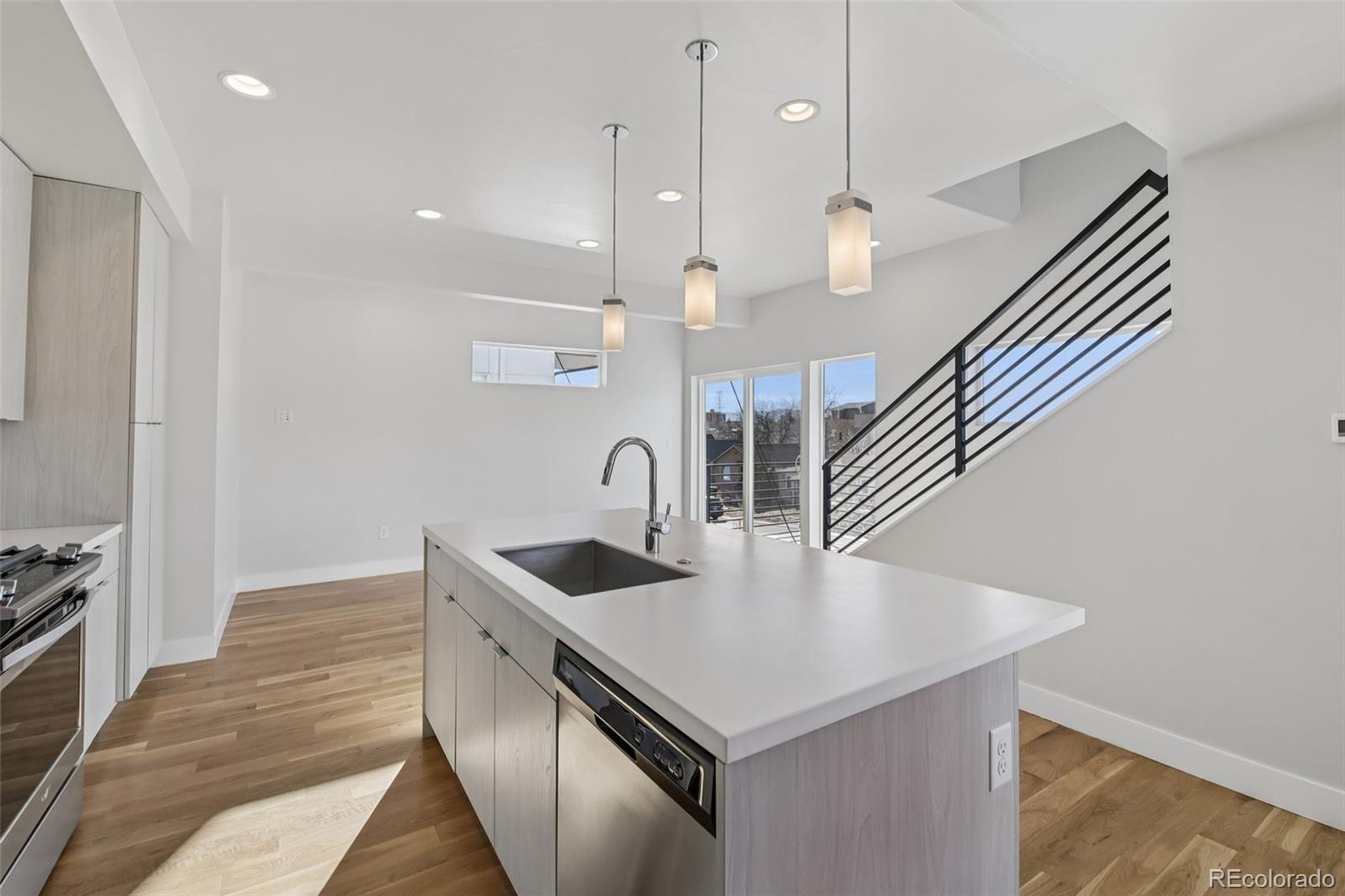 1274 Quitman Street, Unit 6 Denver, CO 80204 - Photo 13 of 50 a kitchen with stainless steel appliances granite countertop a sink a oven and a refrigerator