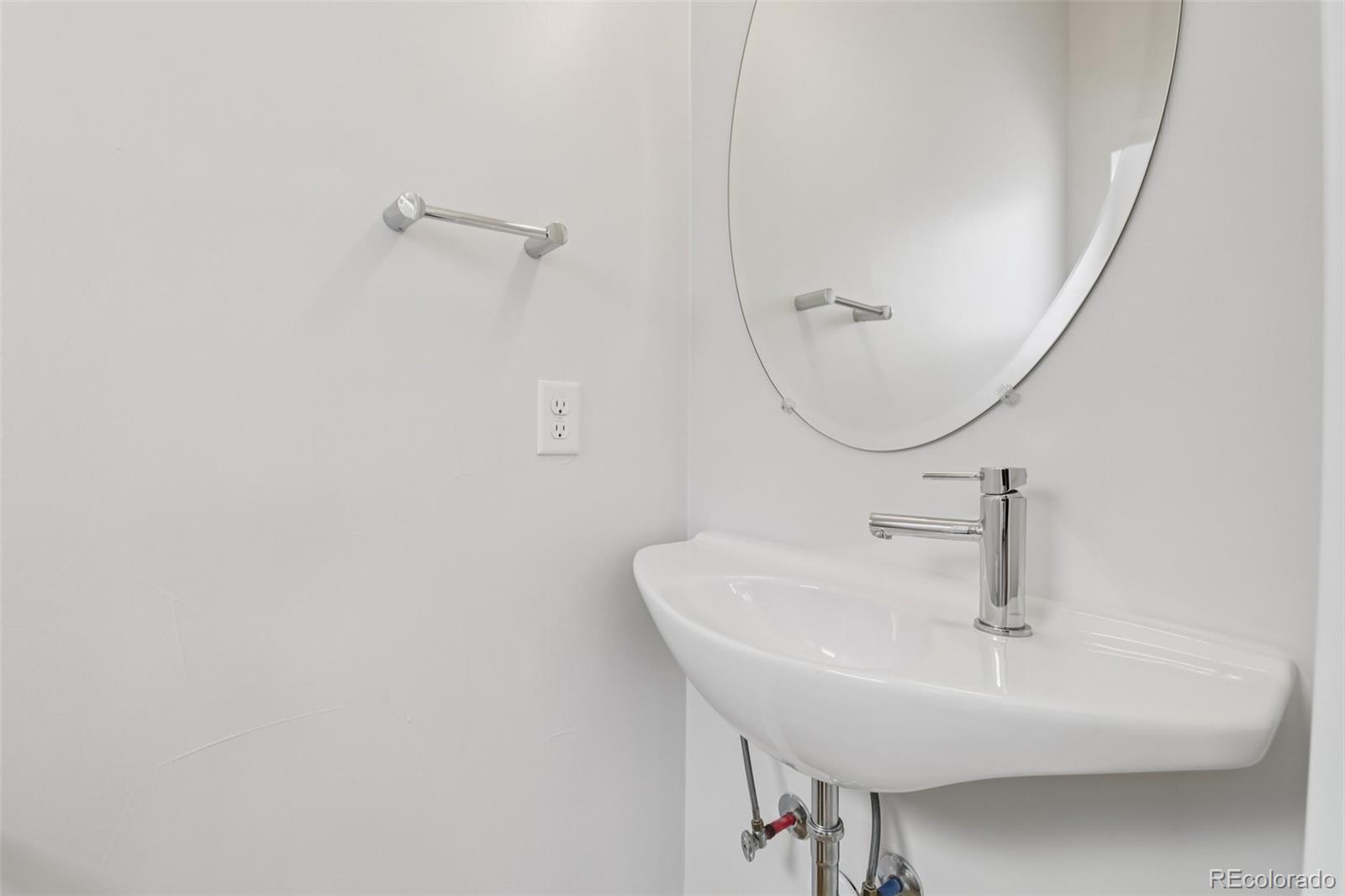 1274 Quitman Street, Unit 6 Denver, CO 80204 - Photo 16 of 50 a bathroom with a sink a mirror and vanity
