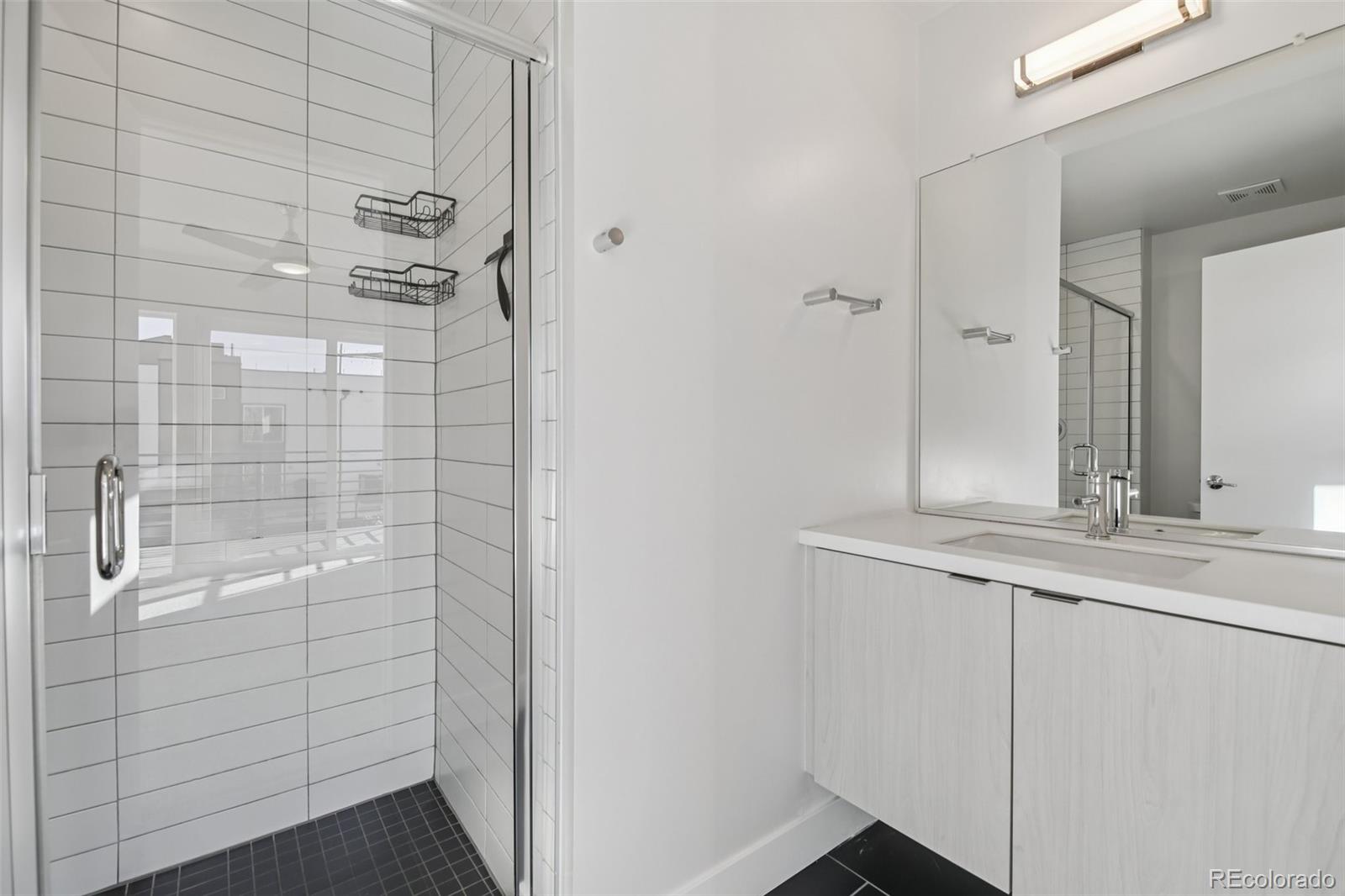 1274 Quitman Street, Unit 6 Denver, CO 80204 - Photo 20 of 50 a bathroom with a sink and mirror
