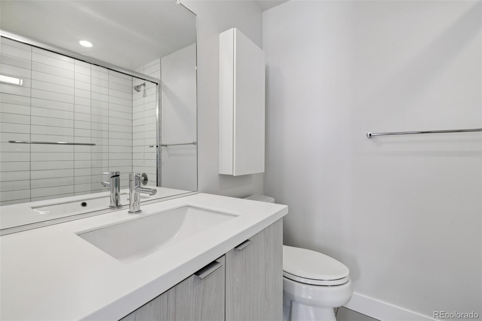 1274 Quitman Street, Unit 6 Denver, CO 80204 - Photo 24 of 50 a bathroom with a sink toilet and a mirror