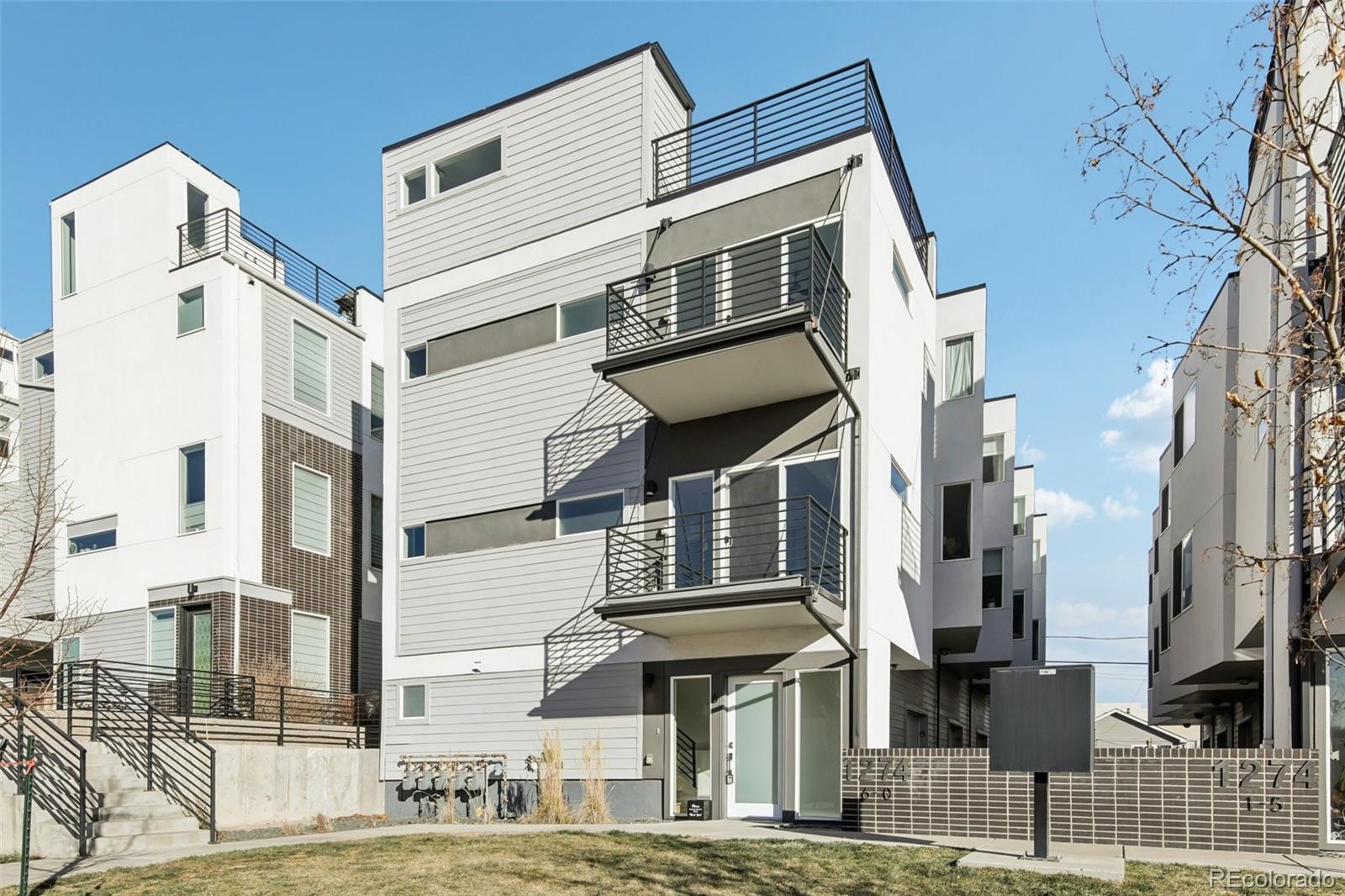 1274 Quitman Street, Unit 6 Denver, CO 80204 - Photo 3 of 50 a front view of a residential apartment building with a yard