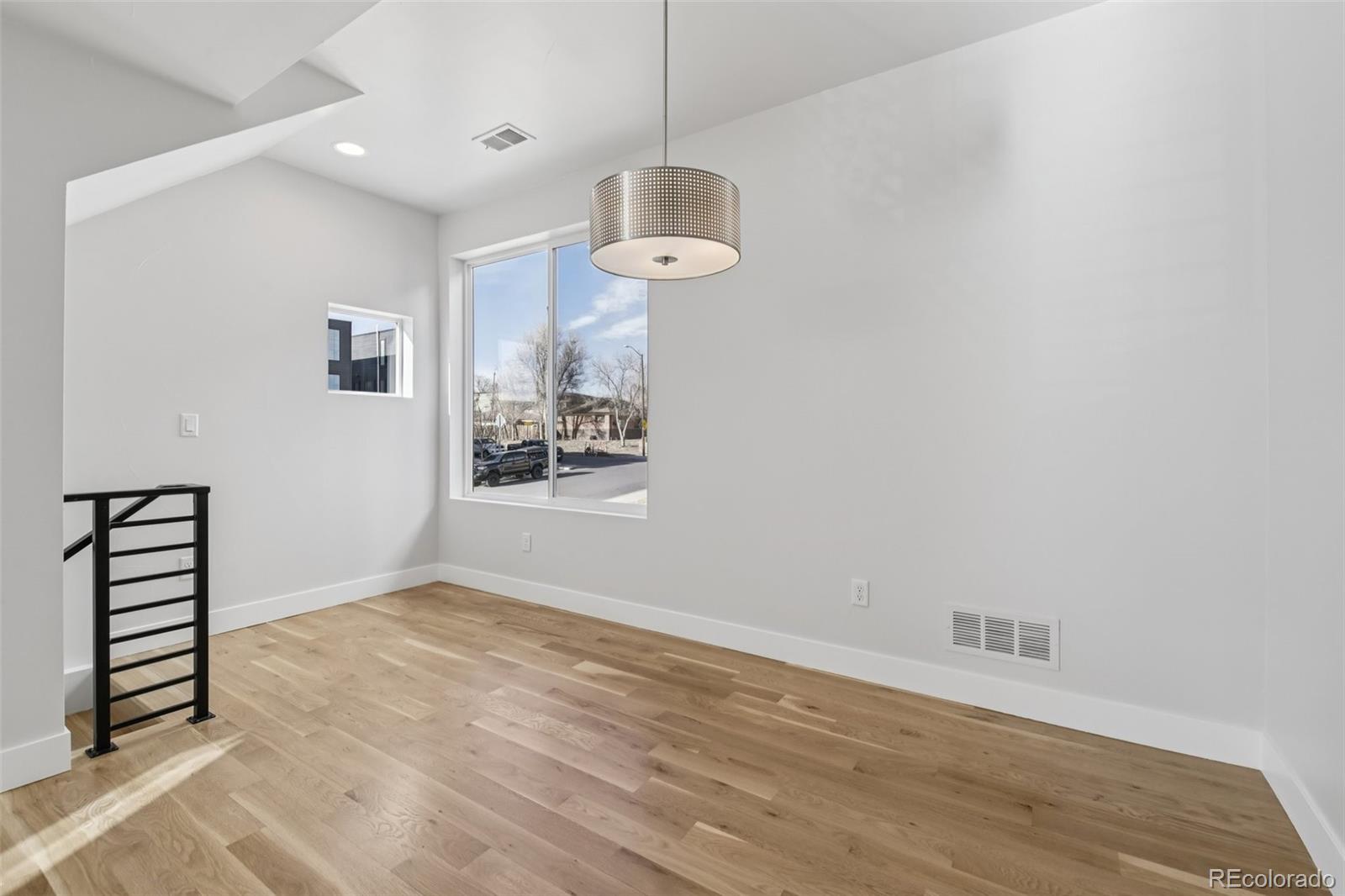 1274 Quitman Street, Unit 6 Denver, CO 80204 - Photo 7 of 50 a view of a room with wooden floor and white walls