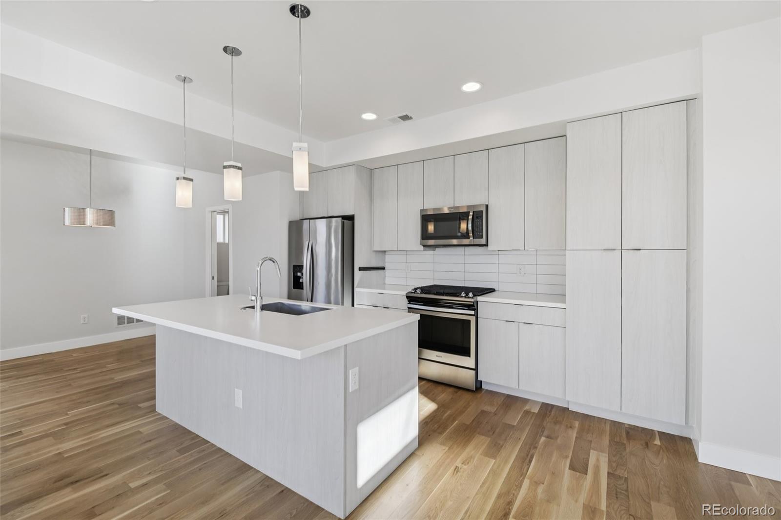 1274 Quitman Street, Unit 6 Denver, CO 80204 - Photo 10 of 50 a kitchen with stainless steel appliances a sink stove and refrigerator