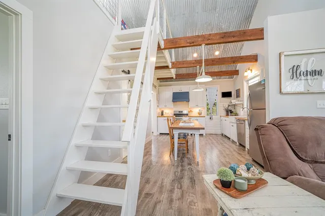 a large kitchen with kitchen island a large counter space a sink appliances and cabinets