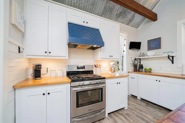 a kitchen with cabinets and stainless steel appliances