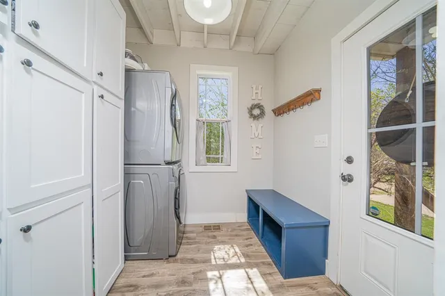 a bedroom with a bed a dresser and a potted plant
