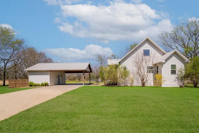 a front view of house with yard and green space