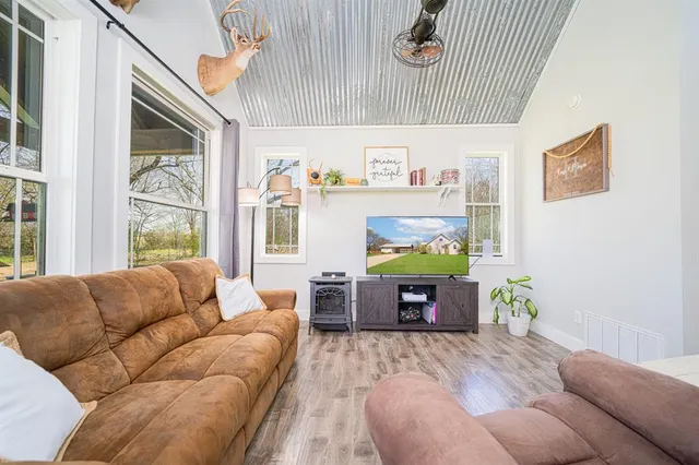 a living room with furniture and wooden floor