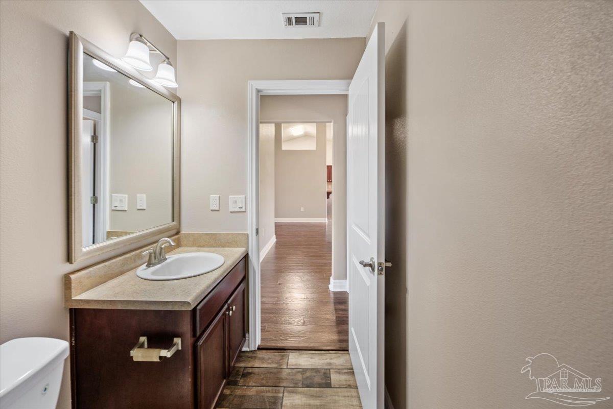 4015 Berry Circle Pace, FL 32571 - Photo 22 of 48 a bathroom with a sink and a mirror