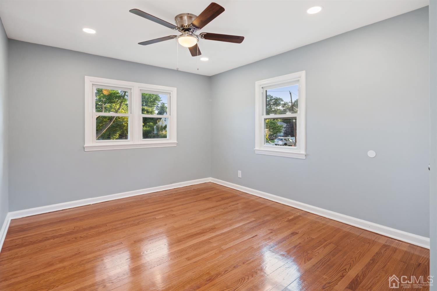 282 Lawrence Avenue North Plainfield, NJ 07063 - Photo 12 of 27 a view of an empty room with a window and wooden floor