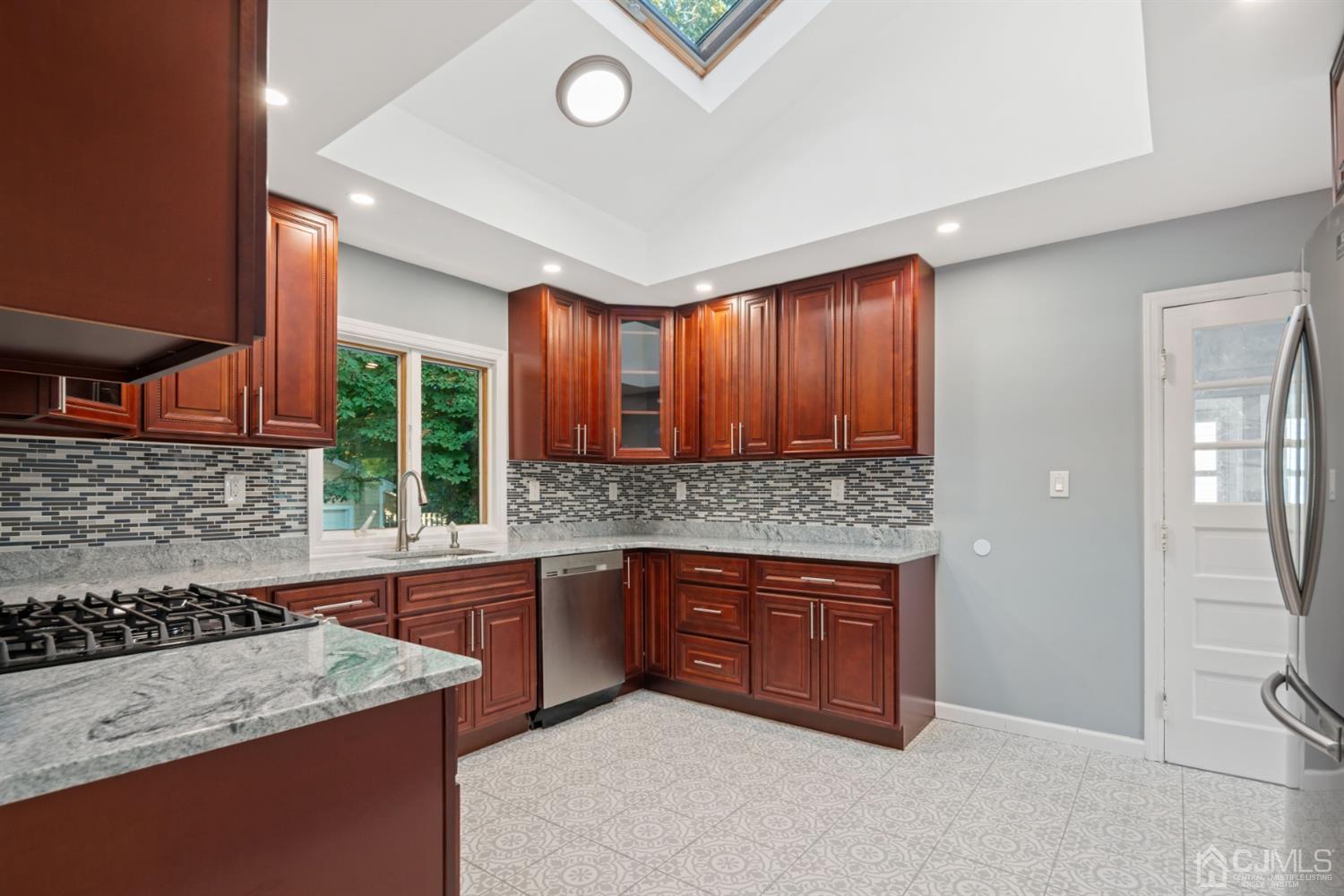 282 Lawrence Avenue North Plainfield, NJ 07063 - Photo 15 of 27 a kitchen with stainless steel appliances granite countertop a stove a sink and a microwave