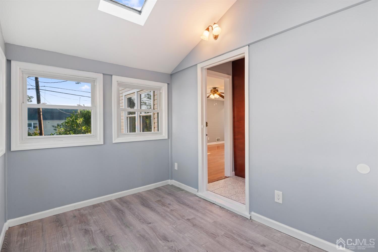 282 Lawrence Avenue North Plainfield, NJ 07063 - Photo 16 of 27 an empty room with wooden floor and windows