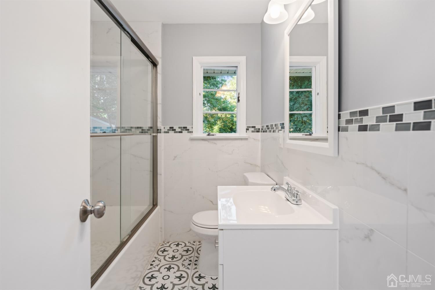 282 Lawrence Avenue North Plainfield, NJ 07063 - Photo 19 of 27 a bathroom with a sink and a mirror