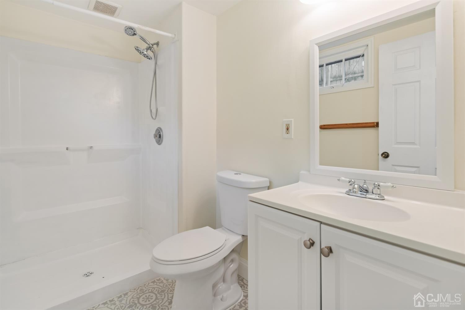 282 Lawrence Avenue North Plainfield, NJ 07063 - Photo 20 of 27 a bathroom with a sink a toilet and shower