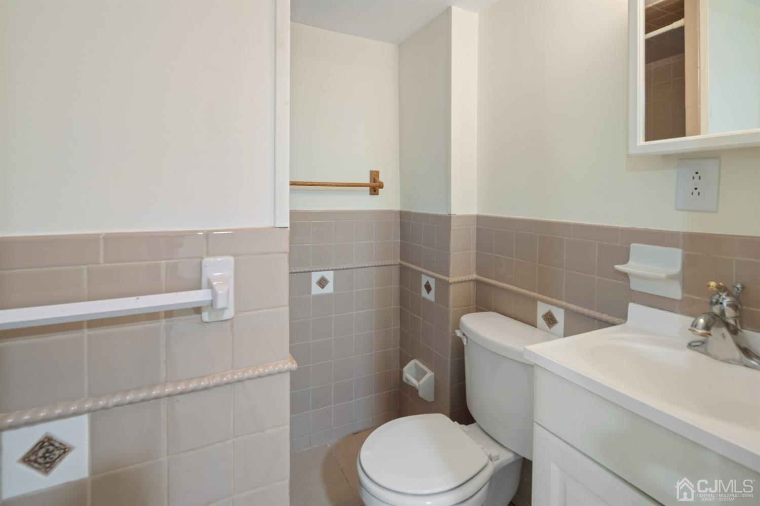 282 Lawrence Avenue North Plainfield, NJ 07063 - Photo 27 of 27 a white toilet sitting next to a bathroom sink