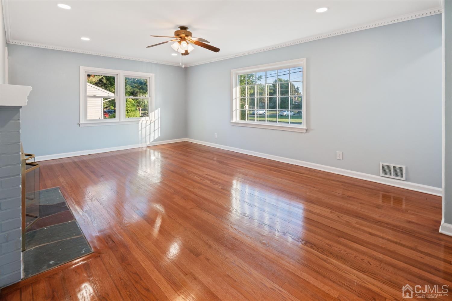 282 Lawrence Avenue North Plainfield, NJ 07063 - Photo 6 of 27 a view of an empty room with wooden floor and a window