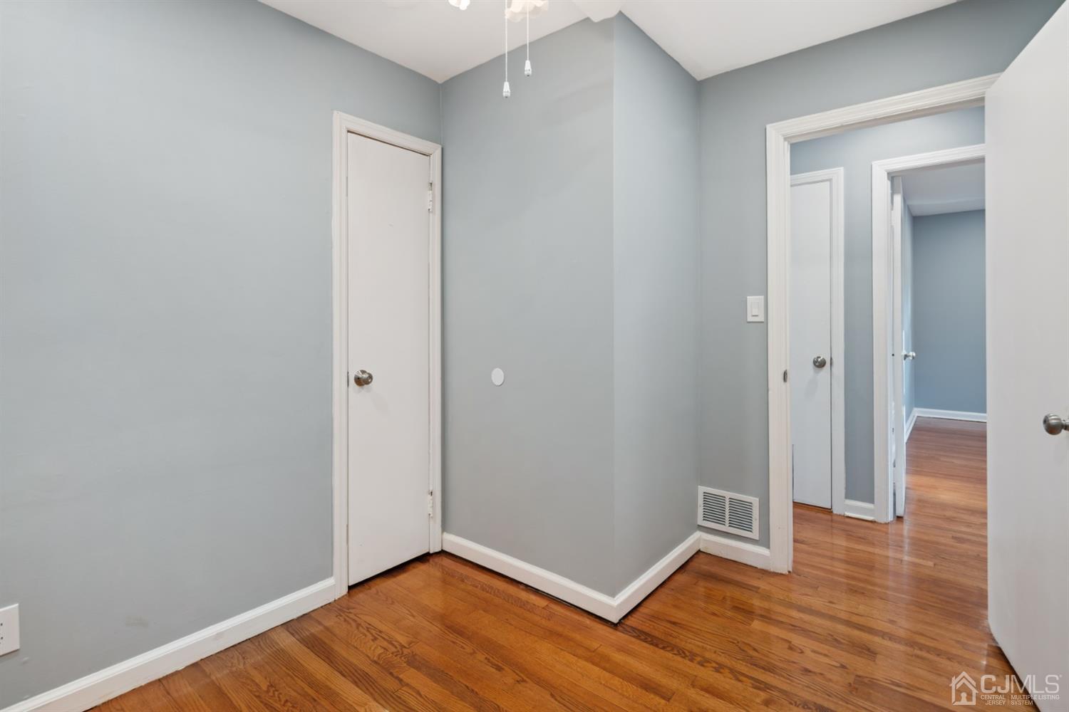 282 Lawrence Avenue North Plainfield, NJ 07063 - Photo 9 of 27 a view of an empty room with wooden floor and closet