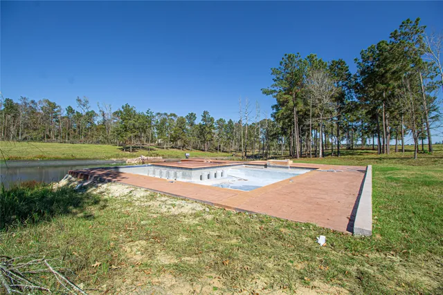 a view of a swimming pool with an outdoor space and seating area