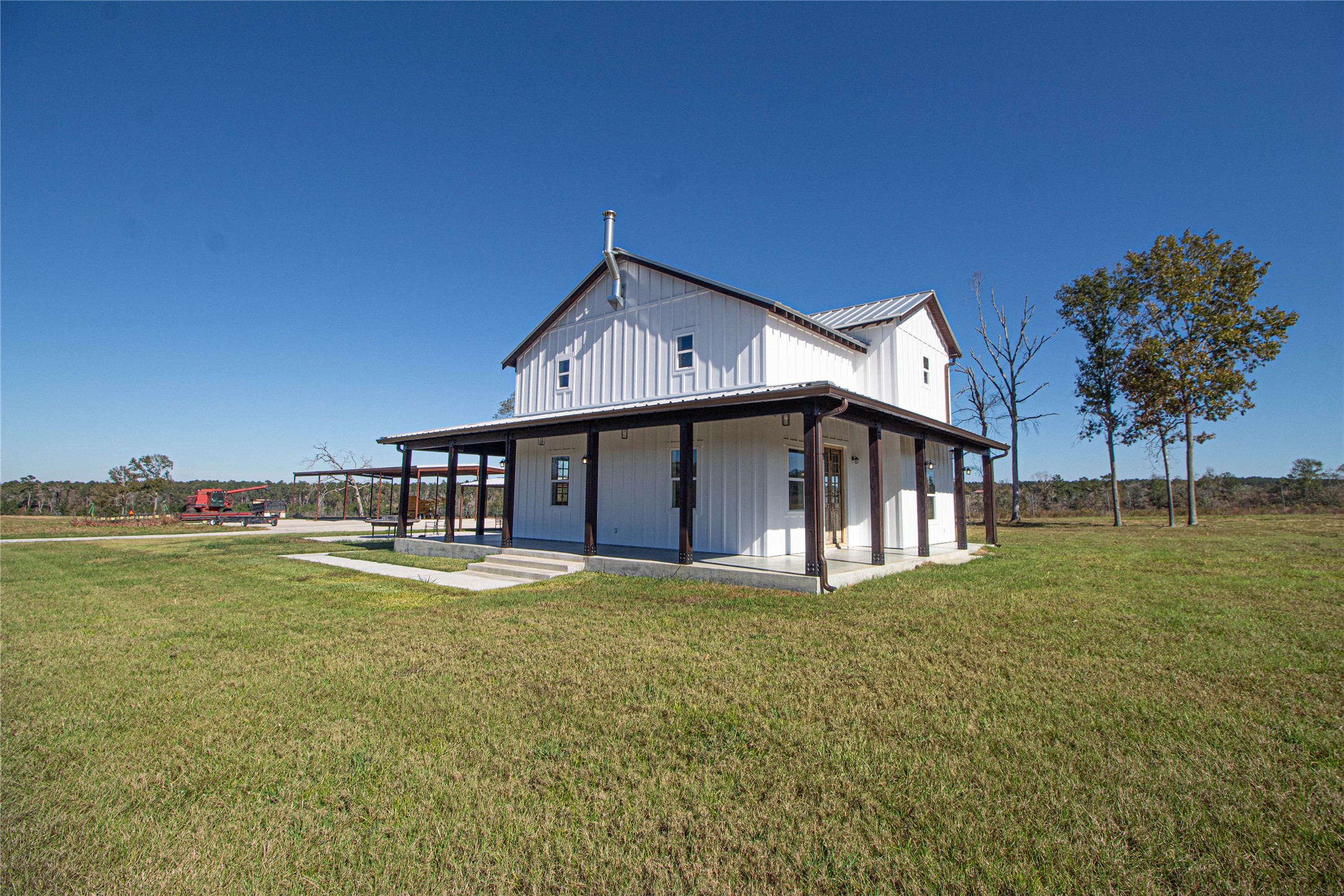 1275 Castlewood Road Livingston, TX 77351 - Photo 2 of 50 a white house that has a big yard with wooden fence