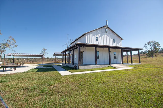 a big house with a big yard and large trees